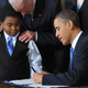 President Barack Obama signs the health-insurance-reform bill as 11-year old Marcelas Owens of Seattle looks on with Vice President Joe Biden on March 23, 2010, in the East Room of the White House.
MANDEL NGAN/AFP/Getty Images